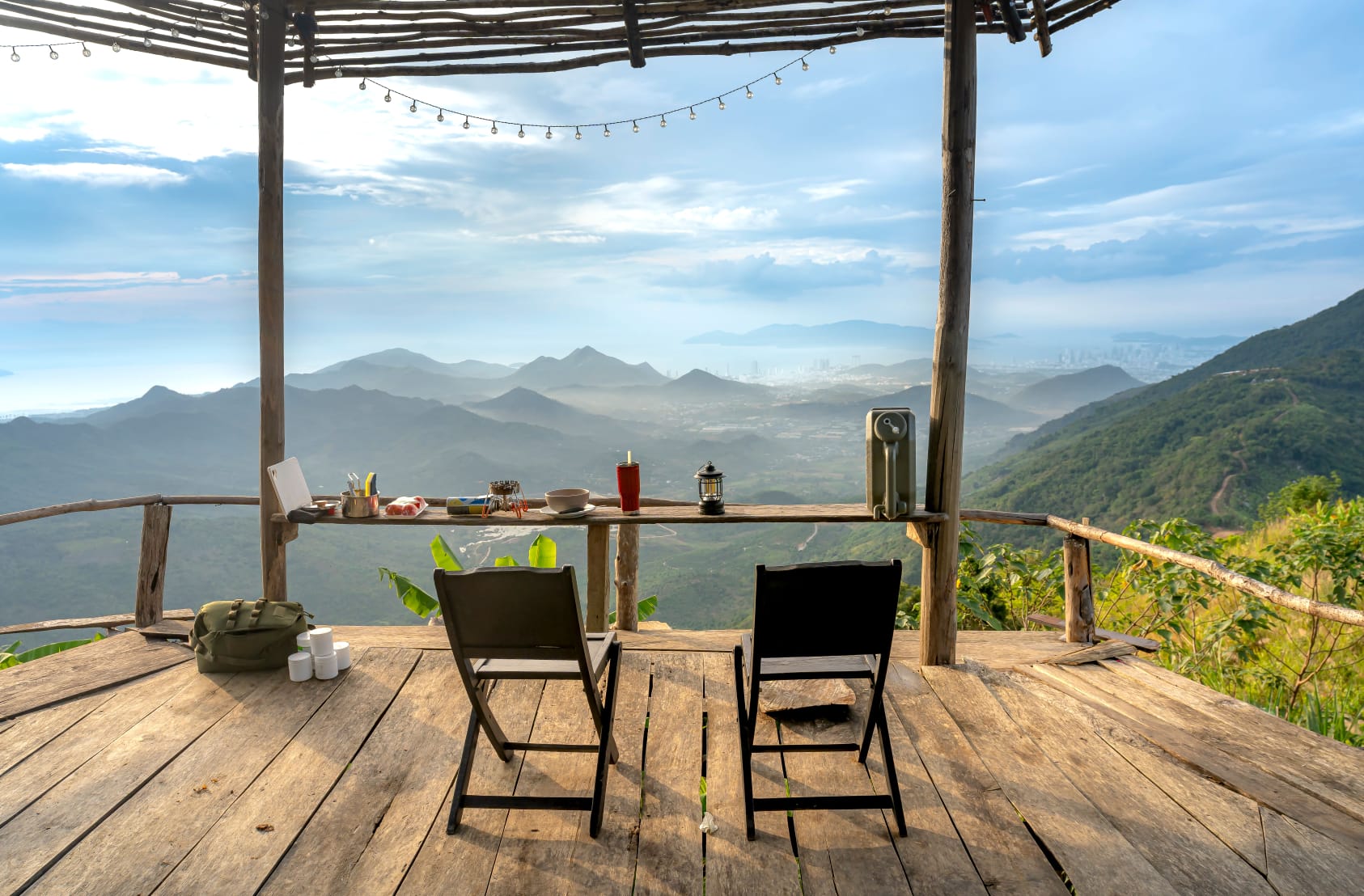 Mountain vista seen from a wooden terrace with chairs