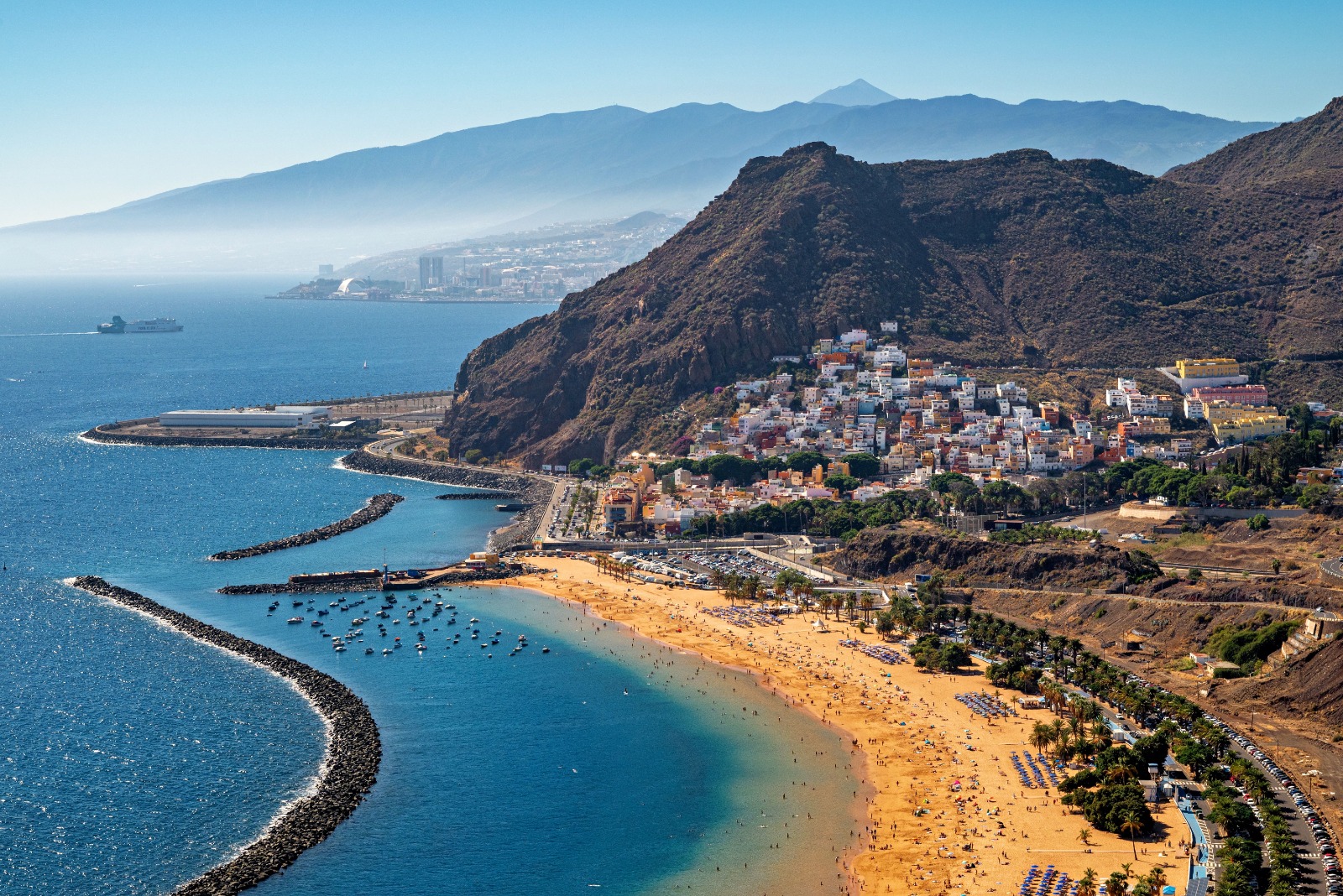 Coastal bay with a sandy beach, cliffs and hillside town